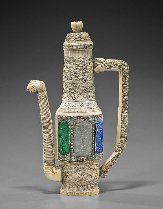Tall Chinese Carved Ivory Ewer: Tall Chinese Carved Ivory EwerVery elaborately detailed and tall, Chinese carved ivory wine ewer and cover; sectional dragon handle, phoenix spout: the body with all-over dragon amid cloud carvings wi