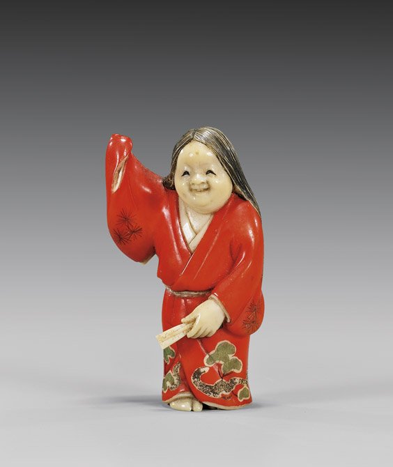 CARVED & LACQUERED IVORY NETSUKE: 象牙漆根付 CARVED & LACQUERED IVORY NETSUKE Beautifully lacquered and finely carved, ivory netsuke; of Okame standing in a red robe, and holding fan in her left hand; sig