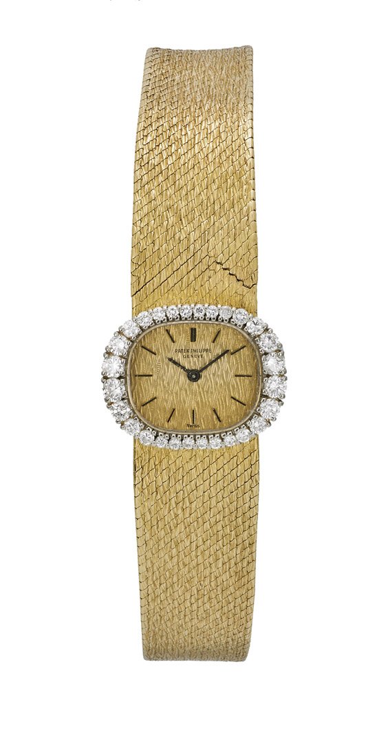 18K LADIES' PATEK PHILIPPE WRISTWATCH: 18K黃金鑲鑽女式腕錶 18K LADIES' PATEK PHILIPPE WRISTWATCHLadies' Patek Philippe, 18K yellow gold wristwatch; the oval dial surrounded by graduated round