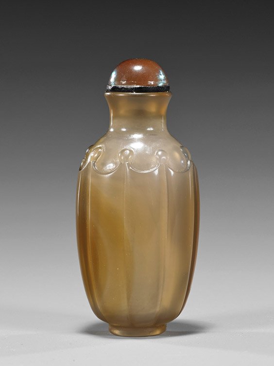 Translucent Grey Chalcedony Agate Snuff Bottle: Translucent Grey Chalcedony Agate Snuff BottleWell hollowed, old translucent gray chalcedony agate snuff bottle; of octagonally lobed form, with raised bosses at shoulder, iridescent glass stopper (us