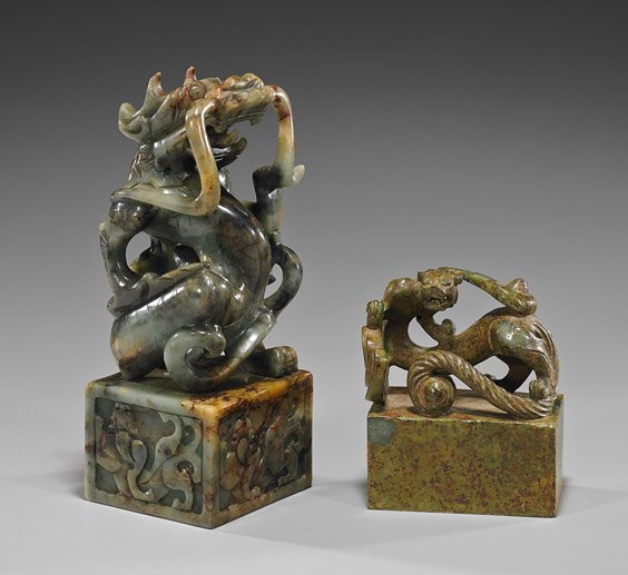 Two Chinese Archaistic Carved Jade Seals: Two Chinese Archaistic Carved Jade Seals Two Chinese archaistic carved jade seals; the taller somewhat amusing and elaborately carved mottled green coloration, square form with hydra panels and surmou