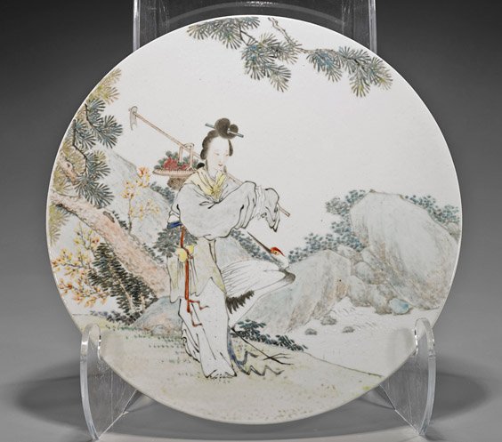 Chinese Enameled Porcelain Plaque: Chinese Enameled Porcelain Plaque Chinese enameled porcelain plaque; of circular form depicting a heavily robed lady with farming tool, basket of fruits and a crane beside her, walking in a landscape 