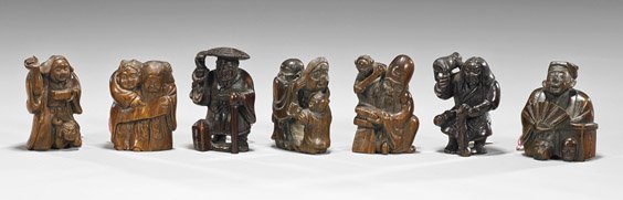 Seven Carved Wood Netsuke: Figures & Attendants: Seven Carved Wood Netsuke: Figures & Attendants Group of seven carved wood netsuke: four single standing figures all holding different objects, and three figures with attendants all in various stages 