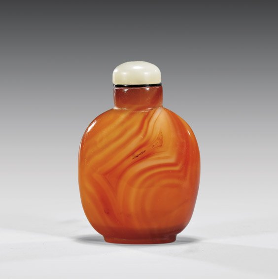 FINE CARNELIAN AGATE SNUFF BOTTLE: 瑪瑙雕鼻煙壺 FINE CARNELIAN AGATE SNUFF BOTTLE Finely hollowed, carnelian agate snuff bottle; of squared form with rounded shoulders, showing attractive banded patt
