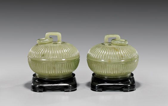 PAIR CARVED JADE COVERED BOXES: 玉雕蓋盒 一對 PAIR CARVED JADE COVERED BOXESPair of fine, Chinese carved jade covered and footed boxes; each of rounded, fluted form; each pending a loose ring from
