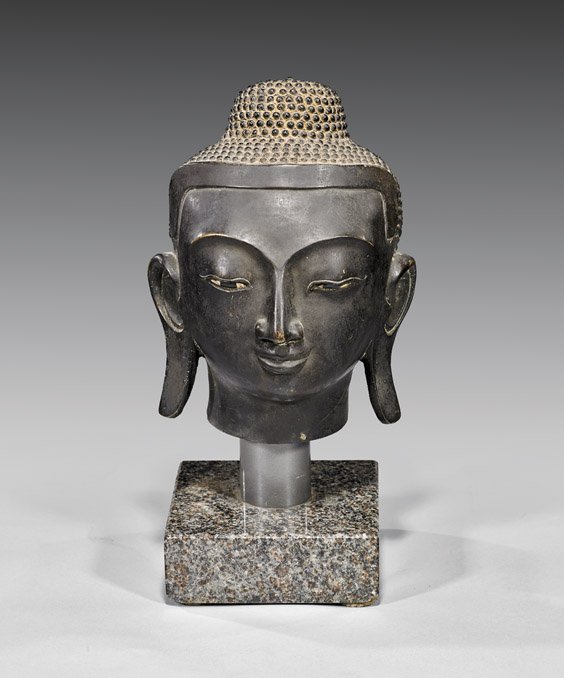 ANTIQUE BURMESE BRONZE HEAD OF BUDDHA: 銅雕佛首 ANTIQUE BURMESE BRONZE HEAD OF BUDDHA Antique Burmese Mandalay Period, bronze head of Buddha; well cast and with very stylized, sharp distinctive features, and typical