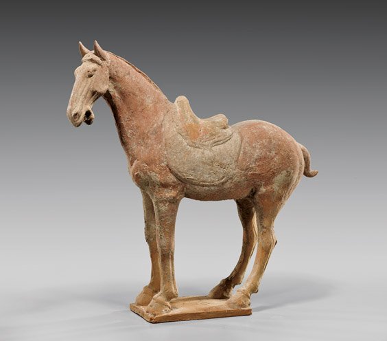 HAN DYNASTY POTTERY HORSE: 陶馬俑 HAN DYNASTY POTTERY HORSE Chinese Han Dynasty pottery model; of a saddled horse with pointed ears and with mouth agape, standing four-square on a rectangular base; showing som