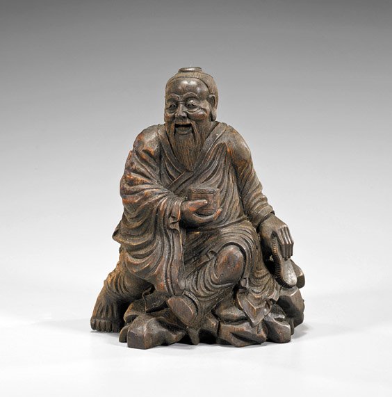 Chinese Carved Bamboo Man: Chinese Carved Bamboo Man Chinese carved bamboo man; of a seated scholar atop rockery, holding a jar in his right hand; H: 7 1/2"
