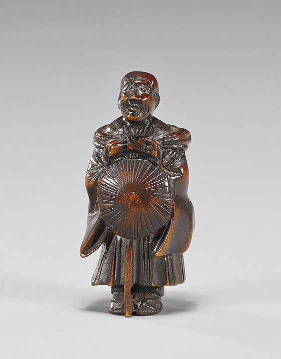 Antique Carved Wood Netsuke: Traveling Monk: Antique Carved Wood Netsuke: Traveling Monk Antique carved wood netsuke; of a standing traveling monk holding his gasa at his stomach, signed by Tomosei (?)