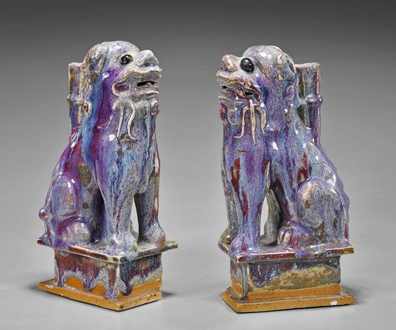 Pair Chinese Flambé Glazed "Fo Dogs": Pair Chinese Flambé Glazed "Fo Dogs"Pair of Chinese flambé glazed porcelain models; in the form of sitting "Fo Dogs" atop pedestal, the thick glaze pooling at the bottom (chips to base and old repai