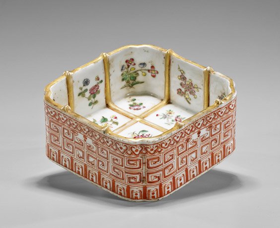 Unusual Chinese Coral Red Porcelain Planter: Unusual Chinese Coral Red Porcelain PlanterUnusual Chinese coral red glazed porcelain planter; of square quatrefoil form, the interior with gilt sectionals of various flowers, the exterior of meander