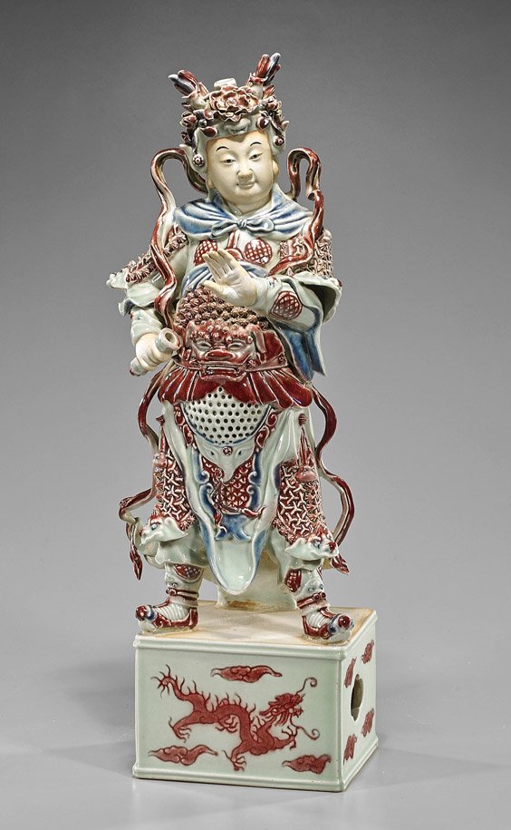 Chinese Porcelain Model of a Warrior: Chinese Porcelain Model of a Warrior Chinese red and blue glazed porcelain model of a warrior; standing on a square base with dragon and flaming pearl, the warrior in moulded elaborate armor and helme