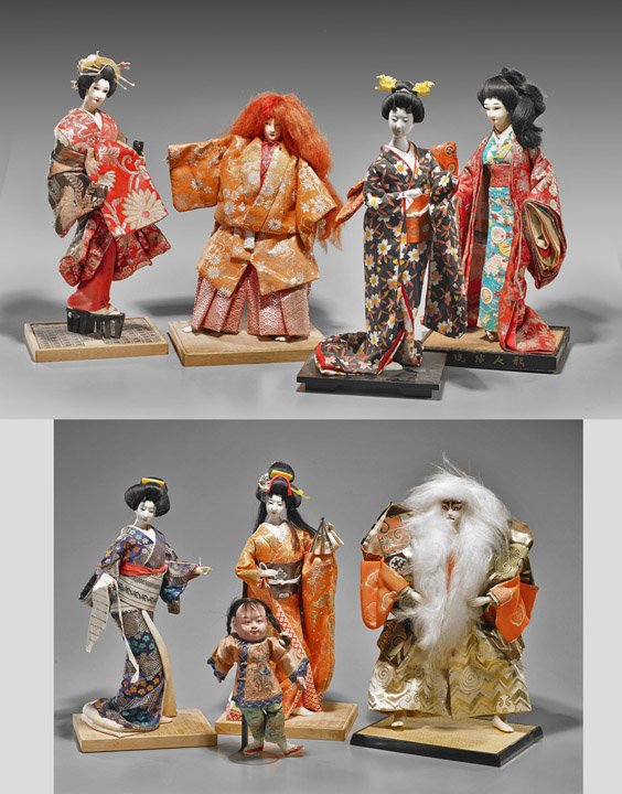 Group of Eight Japanese Dolls: Group of Eight Japanese Dolls Group of eight Japanese dolls with colorful embroidered robes and painted porcelain faces: five geishas in various activities; two performers wearing elaborate costumes; 