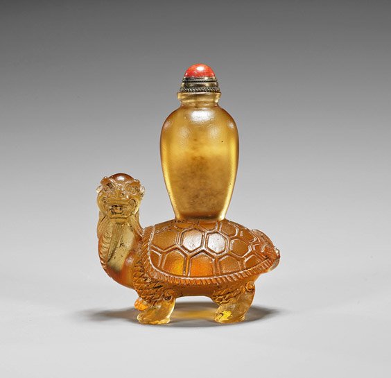 Unusual Dragon Turtle Snuff Bottle: Unusual Dragon Turtle Snuff Bottle Unusual Chinese yellow-glass snuff bottle; of mythical dragon turtle form with urn atop shell, copper stopper with coral cabochon (some wear); H: 3"