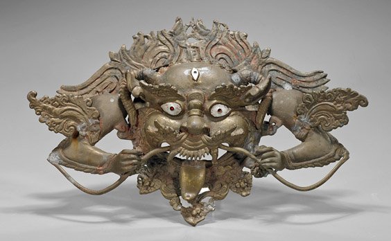 Heavy Sino-Tibetan or Nepalese Bronze Mask: Heavy Sino-Tibetan or Nepalese Bronze Mask Heavy Sino-Tibetan or Nepalese bronze mask; of a deity with a third eye and down cast horns, the mouth open with tongue stuck to chin, some remaining pigment