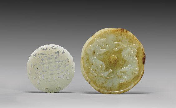 TWO CARVED JADES PLAQUES: 玉雕圓形掛牌 兩件 TWO CARVED JADES PLAQUESTwo Chinese carved jade plaques: round openwork white jade pendant centering a "double happiness" character fl