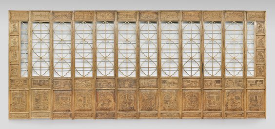 TWELVE-PANEL CARVED WOOD SCREEN: 木雕人物紋屏風 十二扇 TWELVE-PANEL CARVED WOOD SCREEN Chinese twelve-panel wood screen; each panel with open center, above finely carved, na