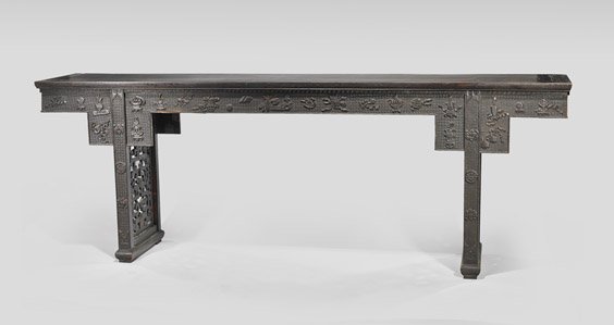 ANTIQUE CARVED WOOD ALTAR TABLE: 木雕吉祥紋條案 ANTIQUE CARVED WOOD ALTAR TABLE Antique Chinese carved wood altar table; the long rectangular form set on two openwork panel legs; the apron ca