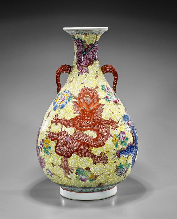 Tall Chinese Famille Rose Dragon Vase: Tall Chinese Famille Rose Dragon VaseTall Chinese Famille Rose enameled porcelain vase; of bottle form with dragon handles, depicting writhing dragons amid blossoming flowers on yellow ground, seal ma