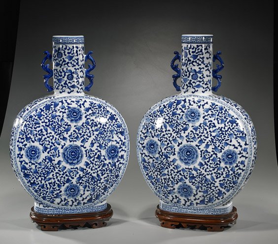 Pair Large Blue & White Porcelain Moon Flasks: Pair Large Blue & White Porcelain Moon Flasks Pair extremely large, Chinese antique-style blue and white porcelain moon flasks; each with allover designs of Buddhist florals and scrolling foliage; H: 