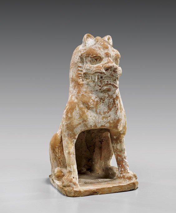 Tang Dynasty Pottery Seated Lion: Tang Dynasty Pottery Seated LionChinese Tang Dynasty pottery model; of a stylized lion seated on its haunches; with well detailed facial features; upon a shaped base (some typical wear and repairs); H