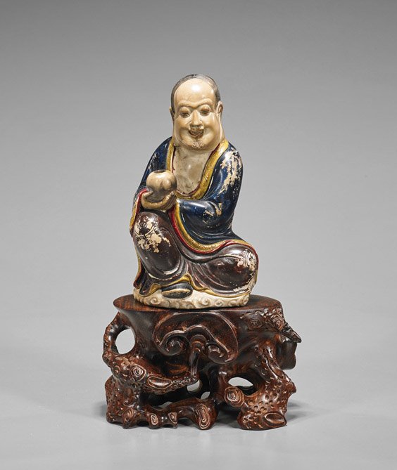 Chinese Carved & Polychromed Soapstone Figure: Chinese Carved & Polychromed Soapstone Figure Chinese carved and polychromed soapstone figure; of a man seated in somewhat "Royal Ease" position with elongated earlobes and jar in right hand (heavy we