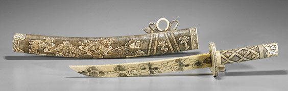 Chinese Carved Bone Short Sword: Chinese Carved Bone Short SwordChinese carved and sectional bone sword: the scabbard with design of sinuous dragon amid clouds; the bone blade with cloud designs; the hilt with writhing dragons (repai