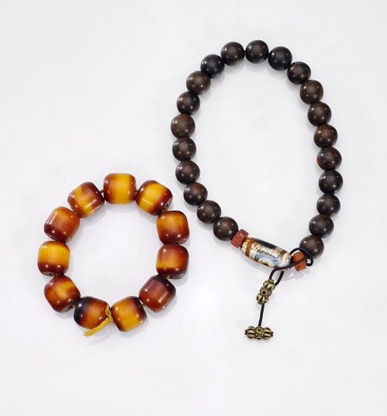 Two Chinese Bead Bracelets: Wood & Amber: Two Chinese Bead Bracelets: Wood & AmberTwo Chinese bracelets: of circular wood beads with ovoid Dzi-type beads and hardstone spacers; together with rounded amber beads; D: 4 3/4" (larger)