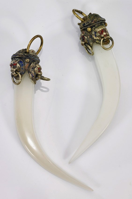 Pair Chinese Glass & Metalwork Pendants: Pair Chinese Glass & Metalwork PendantsPair of Chinese glass imitating jade pendants; in the form of a tooth with painted metalwork cap with lion mask and loose ring motif (wear and minor repairs); L: