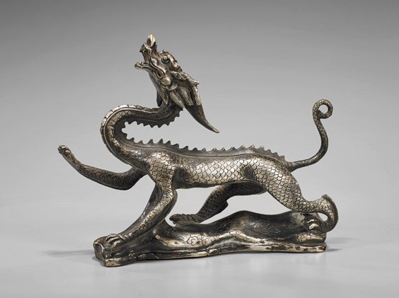 Chinese Silvered Bronze Striding Dragon: Chinese Silvered Bronze Striding Dragon Well detailed, Chinese silvered bronze model of a dragon; the scaly beast in striding form with head tilted back and front right paw lifted atop floating clouds