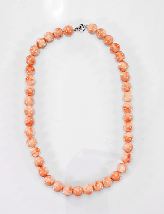 Two Necklaces: Coral & Agate: Two Necklaces: Coral & Agate Well polished coral bead choker necklace comprised of forty-one 11mm round beads of nearly "angel skin" coloration; together with carved carnelian agate openwork oval pend