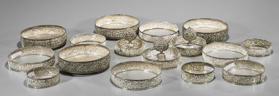 Four Sets Silver Repoussé Stacking Tiers: Four Sets Silver Repoussé Stacking Tiers Four sets of silver repoussé Buddhist stacking tiers: with base, three graduating rings and finial, all with designs of Buddhist emblems, approx. 19 pieces i