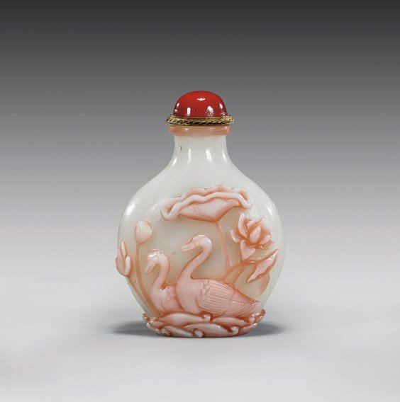 Carved Double-Overlay Glass Snuff Bottle: Carved Double-Overlay Glass Snuff BottleCarved double-overlay glass snuff bottle; of bulbous spade form, with pond design of ducks and lotus to one side and fish and lotus to the other; rendered in pi