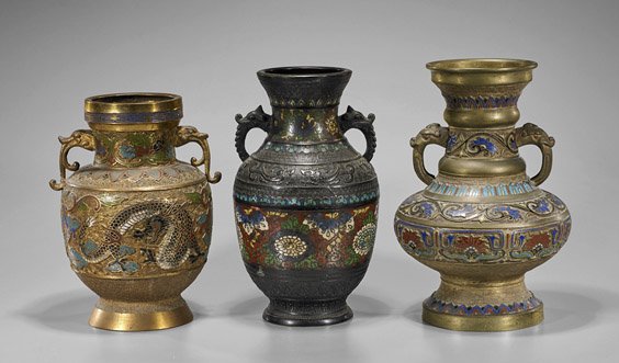 Three Antique Japanese Champlevé Vessels: Three Antique Japanese Champlevé VesselsThree heavy, antique Japanese champlevé enamel bronze vessels, with archaistic scrolling designs and animal head handles: of oval, rounded and baluster form e