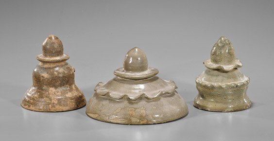 Three Chinese Han Dynasty Glazed Pottery Covers: Three Chinese Han Dynasty Glazed Pottery Covers Group of three Han Dynasty glazed pottery covers: each of three stepped form with peach-like finial: large wider form with foliate rim; taller with two 