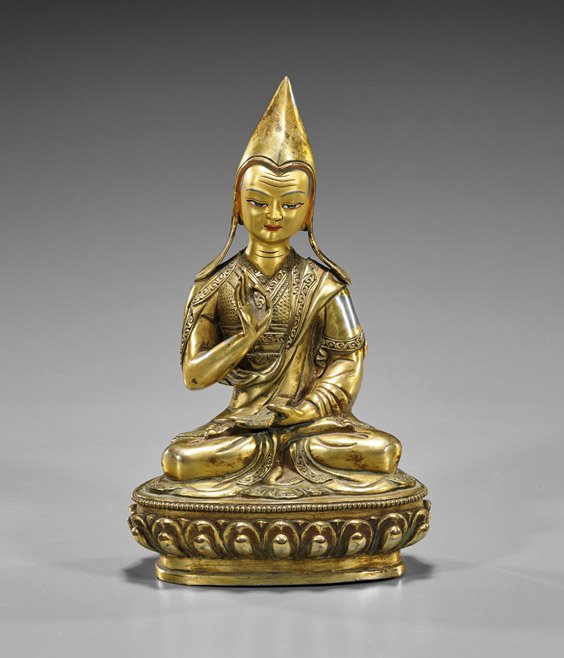 Nepalese/Sino-Tibetan Gilt Bronze Scholar: Nepalese/Sino-Tibetan Gilt Bronze Scholar Nepalese or Tibetan gilt bronze Buddhist scholar; probably of Tsongkhapa, seated in lotus position atop a lotus base, wearing a traditional “yellow sect hat