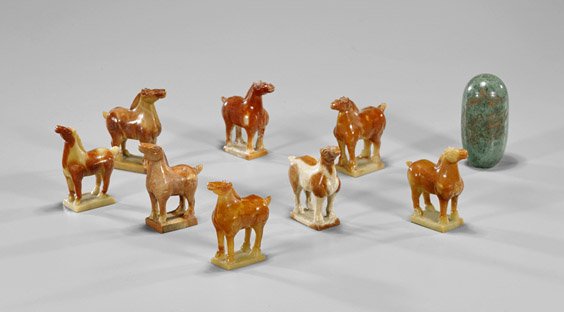 Group of Hardstone Carvings: Horses: Group of Hardstone Carvings: Horses Group of eight carved hardstone horses, each standing four-square upon a plinth, all of mottled auburn coloration; together with tubular form polished hardstone wit