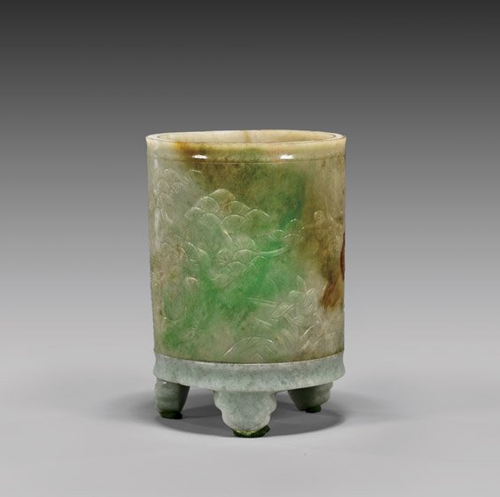 ANTIQUE CARVED JADEITE BRUSHPOT: ANTIQUE CARVED JADEITE BRUSHPOTAntique Chinese jadeite sectional brushpot; of cylindrical form raised on three ruyi-shaped feet, the exterior with design of the Three Friends of Winter (bamboo, pine,
