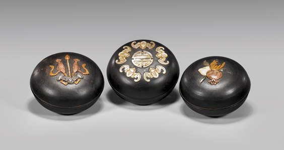 THREE INLAID ZITAN BOXES: THREE INLAID ZITAN BOXESThree Chinese carved and inlaid Zitan wood covered boxes, each of round form: with mother-of-pearl design of bats and Shou medallion; with hardstone double fish chime; and hard