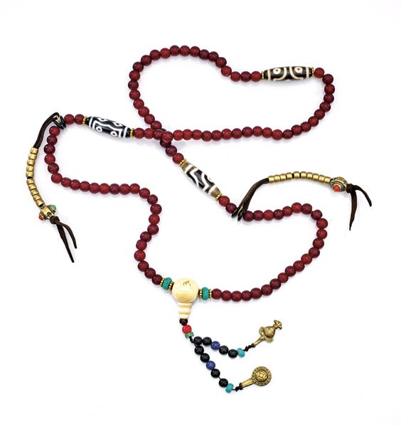 GLASS & DZI PRAYER BEAD NECKLACE: GLASS & DZI PRAYER BEAD NECKLACE Buddhist prayer bead necklace; comprised of red glass round beads, with three large dzi agate beads; ivorine endcap; pending short lengths of gilt metal accents and tw