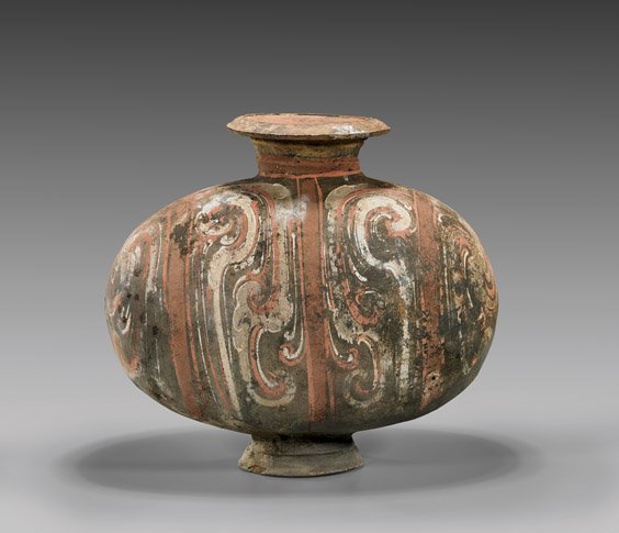 HAN DYNASTY PAINTED POTTERY COCOON VASE: HAN DYNASTY PAINTED POTTERY COCOON VASE Fine Chinese Han Dynasty, painted pottery cocoon vase; of typical ovoid form set on a short foot; with bold, elaborately painted designs in red, black and white