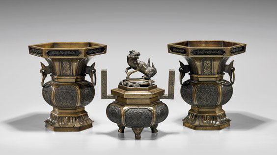 THREE-PIECE JAPANESE BRONZE GARNITURE SET: THREE-PIECE JAPANESE BRONZE GARNITURE SETThree-piece, heavy Japanese bronze garniture set: incense burner of bulbous hexagonal form, the cover with kirin final; together with pair gu-form vases of mat