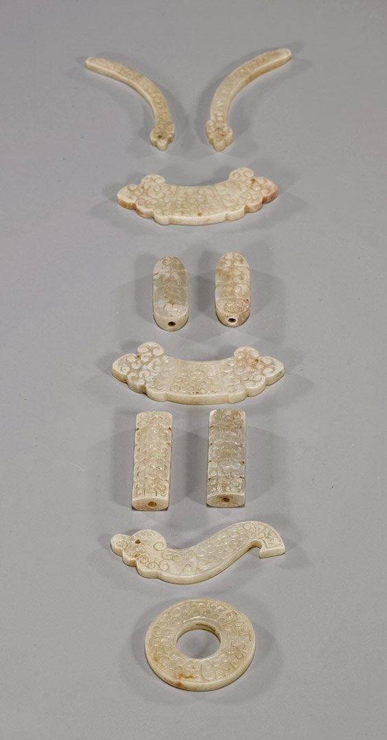 Ten Chinese Archaistic Jade-Like Pendants: Ten Chinese Archaistic Jade-Like PendantsCollection of ten small Chinese jade-like archaistic pendants: four arc-shaped (huang); two tubular; two cong shaped; bi form; together with flattened buckle-l