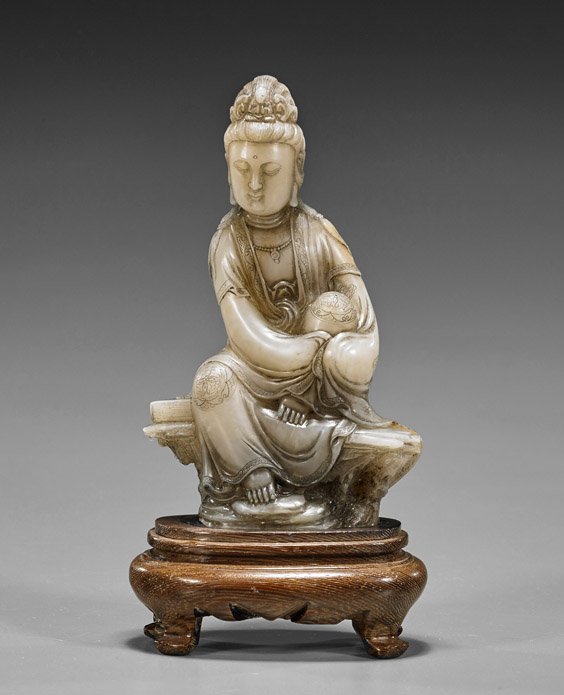 Chinese Carved Soapstone Guanyin: Chinese Carved Soapstone Guanyin Chinese carved soapstone Guanyin; the sitting Bodhisattva in "Royal Ease" upon rockery, in flowing robes and wearing an amitabha crown, several venus rings around neck