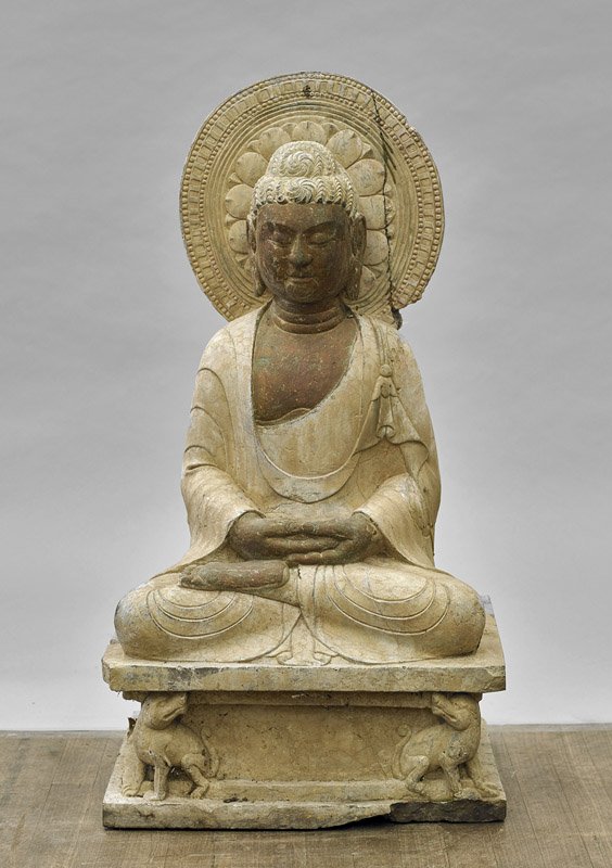 Chinese Carved Stone Seated Deity: Chinese Carved Stone Seated Deity Chinese carved stone deity; of a seated Buddhist figure in lotus position atop pedestal, a serene expression with three Venus rings, a blossom mandorla behind (some p