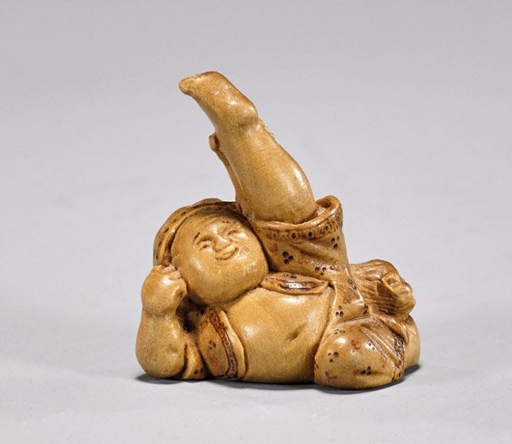 Carved Wood Netsuke by Derkachenko: Carved Wood Netsuke by Derkachenko Carved wood netsuke; of a large bellied man extending his left leg in the air; signed by Alexander Derkachenko (b. 1964); President of the Ukraine Netsuke Society