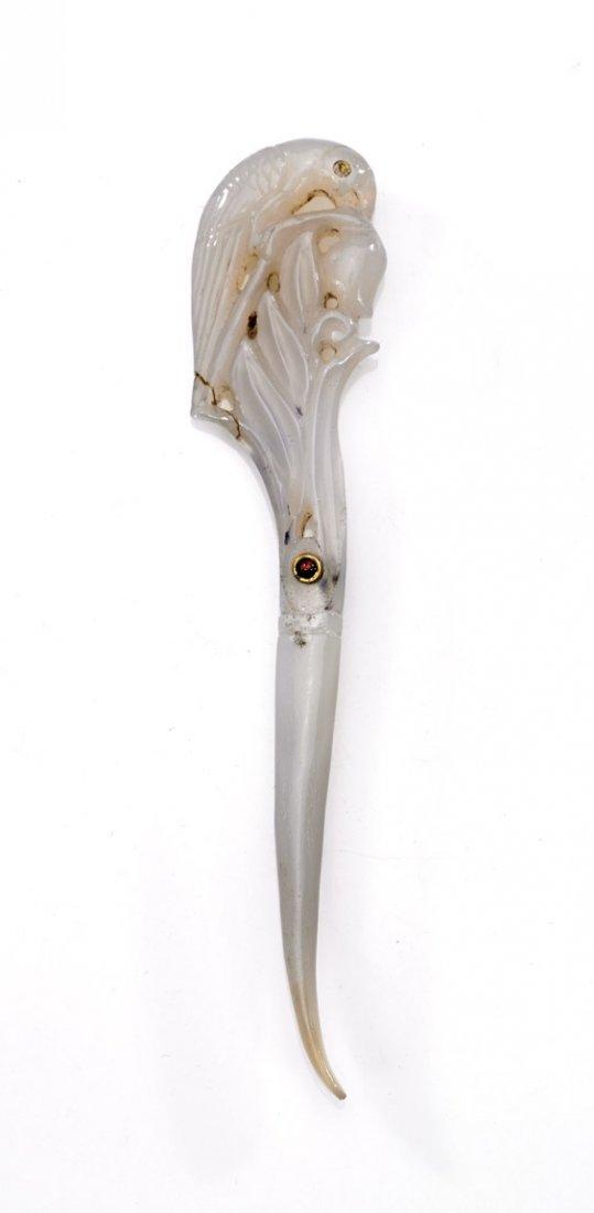 MUGHAL-STYLE AGATE INLAID HAIRPIN: MUGHAL-STYLE AGATE INLAID HAIRPIN Mughal-style carved translucent agate hairpin; with design of a parrot and foliage, with two inlaid red "jewels"; L: 4"