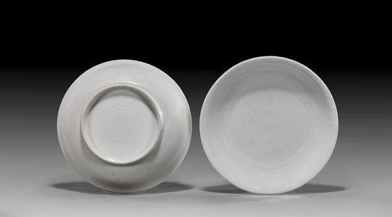 PAIR XUANDE WHITE PORCELAIN DISHES: PAIR XUANDE WHITE PORCELAIN DISHES Extremely rare, pair Chinese early Ming Dynasty, 15th Century white glazed porcelain dishes; each of fine form with gently flaring rim; each with incised Xuande Mark