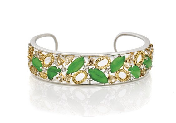 JADE & "FANCY" COLORED DIAMOND BRACELET: JADE & "FANCY" COLORED DIAMOND BRACELET Important jade and diamond cuff bracelet; mounted in 18K white and yellow gold, set with seven nearly transparent Imperial green jade cabochons, set into an ope