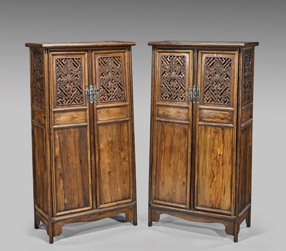 PAIR HUANGHUALI WOOD CABINETS: PAIR HUANGHUALI WOOD CABINETS Pair of Chinese Ming-style huanghuali wood cabinets; each of sloped form, the doors each with reticulated upper panels of carved bat chimes and double fish-pendant design